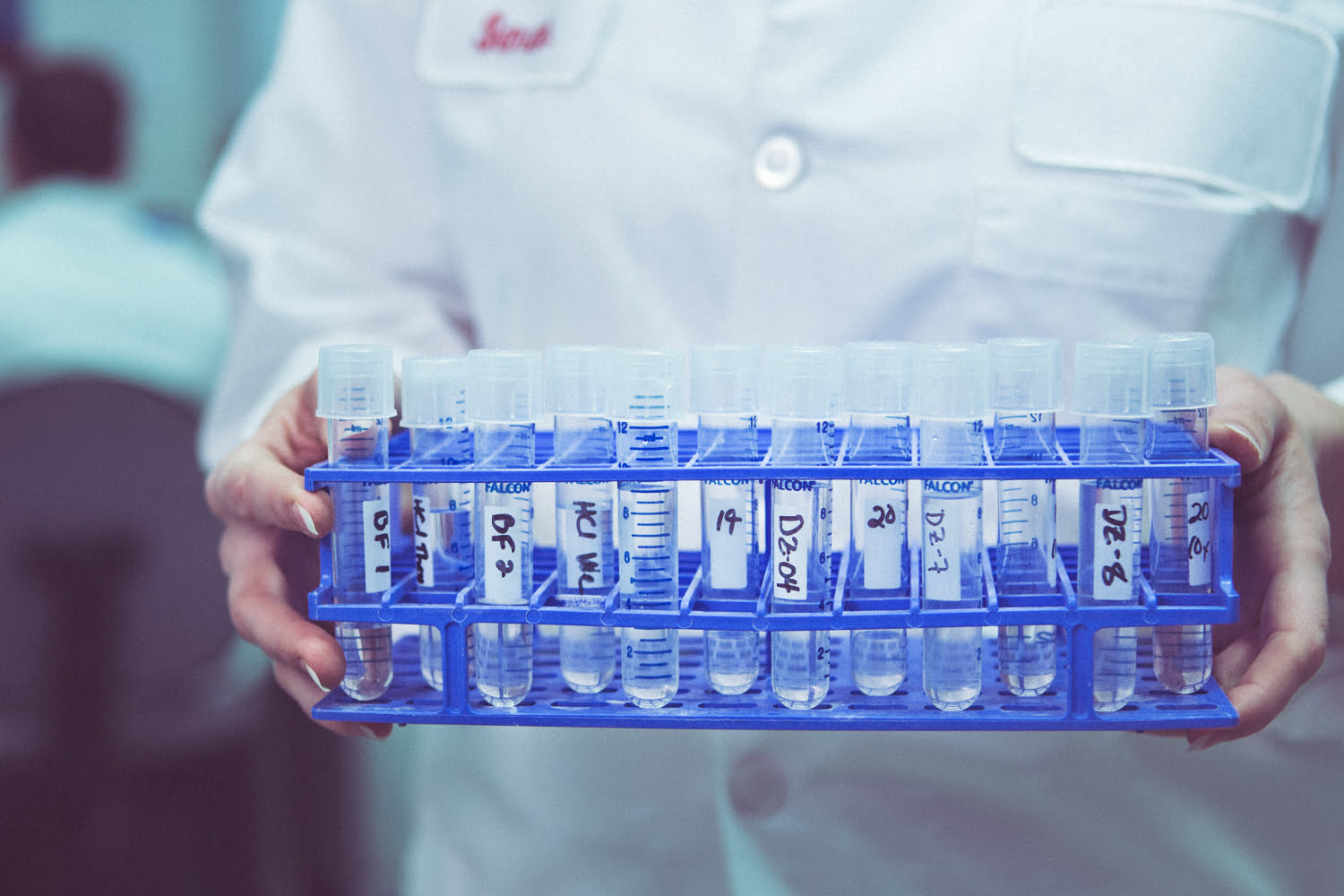 Healthcare Commercial Product Photography - Hands holding tray of vials for testing