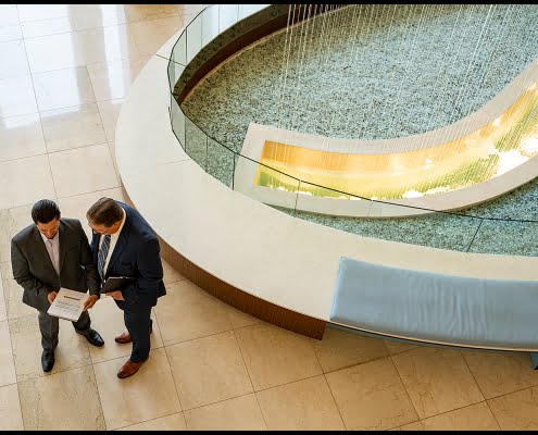 Corporate executives meeting in building lobby