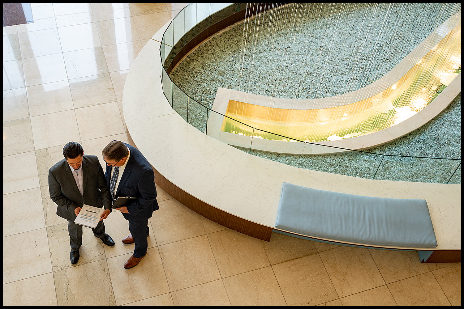 Corporate executives meeting in building lobby