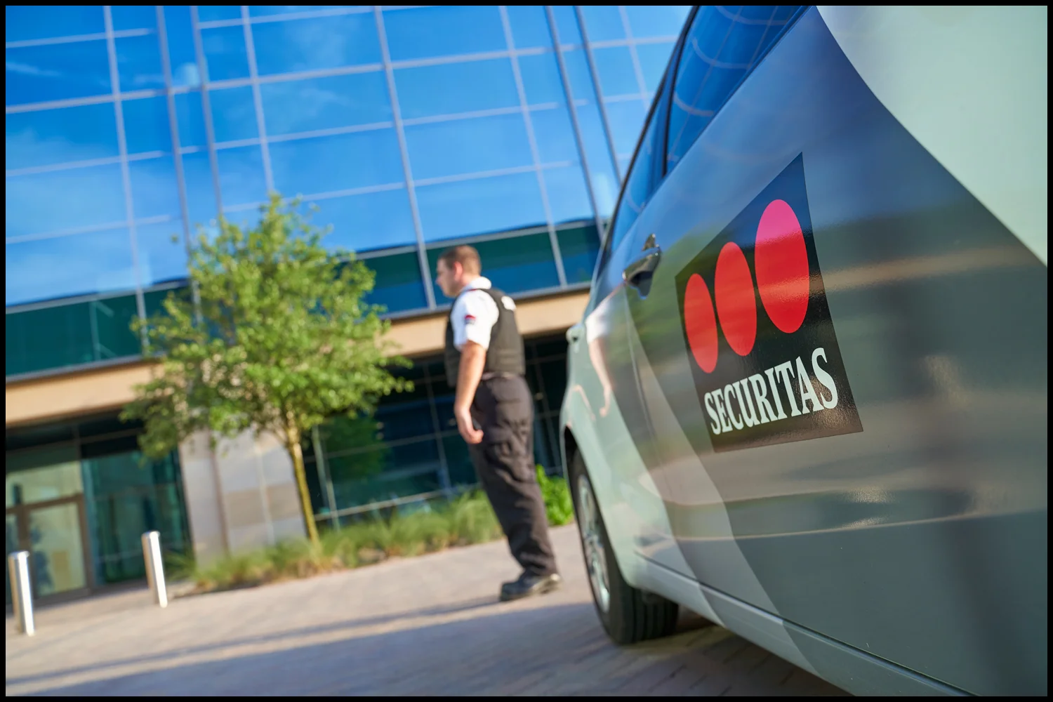 Corporate photography by Michael LoBiondo of security expert with branded car on location Corporate photography of security expert with branded car on location