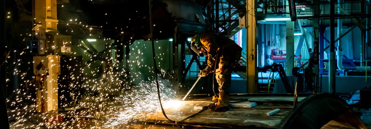 Industrial Photography - Worker cutting metal tank
