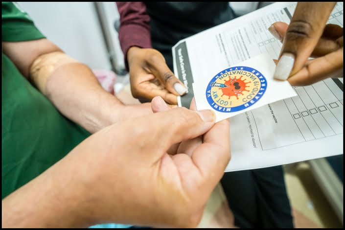 Michael LoBiondo Healthcare Photography Portfolio - Veterans Affairs patient receiving vaccination sticker