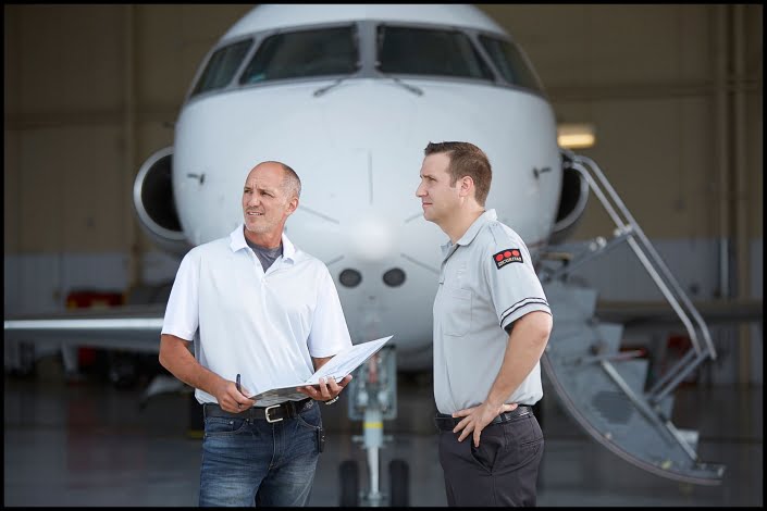 Michael LoBiondo Photography - security officer and pilot in front of private jet hangar