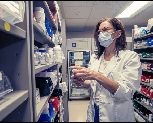 healthcare-veterans-miami-location-surgery-medical Michael LoBiondo Healthcare Photography Portfolio - Veterans Affairs - doctor looking at pharmacy shelves