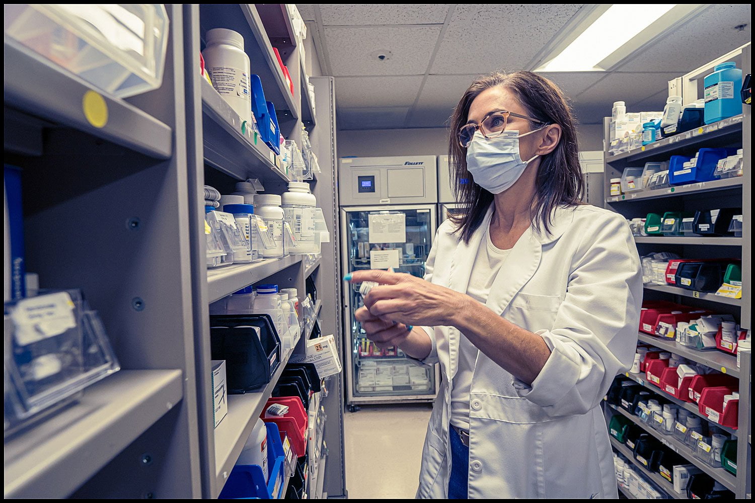 healthcare-veterans-miami-location-surgery-medical Michael LoBiondo Healthcare Photography Portfolio - Veterans Affairs - doctor looking at pharmacy shelves