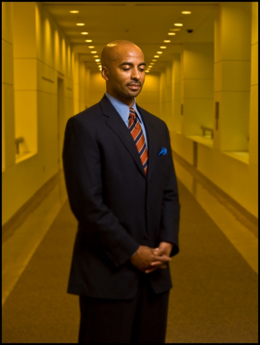 Michael LoBiondo Photography - environmental portrait of corporate executive in hallway with yellow tones