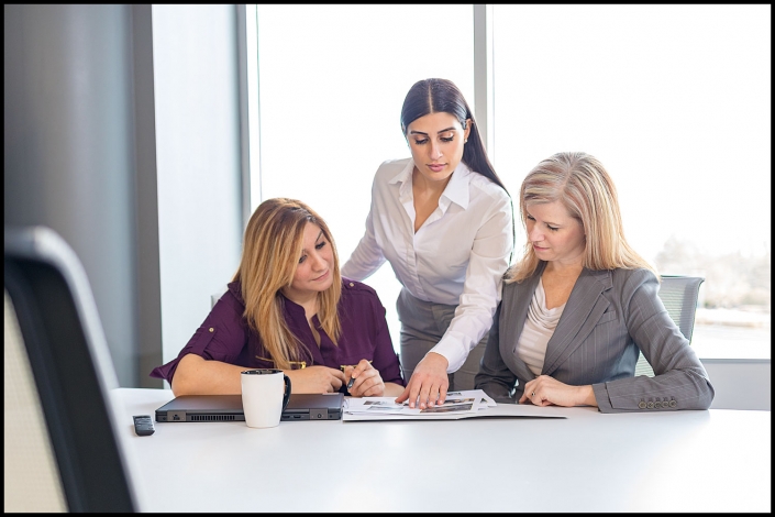 Michael LoBiondo Photography - Three women executives at conference table in bright atmosphere