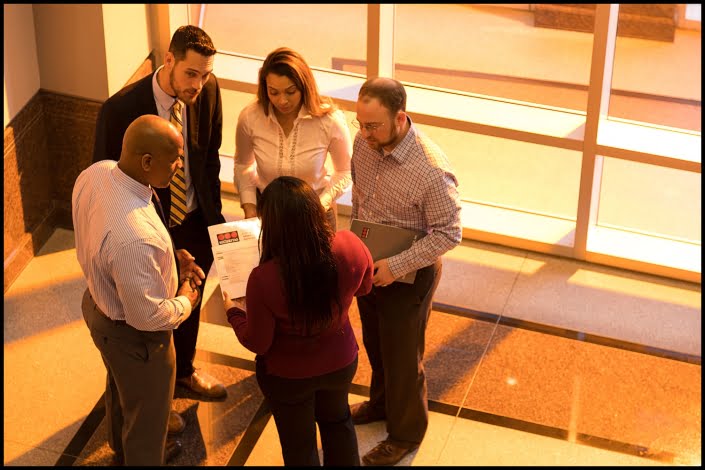 Michael LoBiondo Photography - Team of executives meeting in front of lobby windows at sunset
