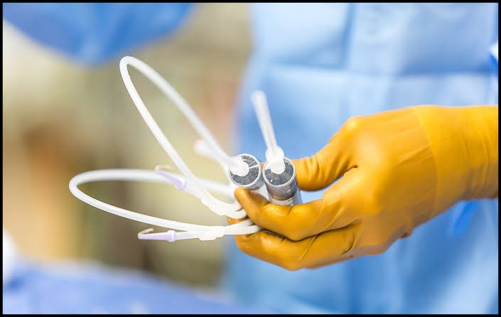MIchael LoBiondo Photography - Yellow gloved hands holding surgical instruments