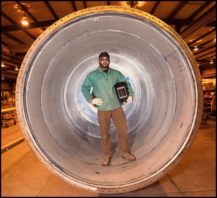 Michael LoBiondo Photography - Environmental portrait of welder in large water pipe