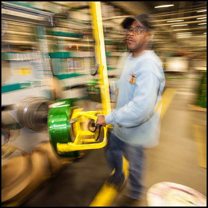 Michael LoBiondo Photography - Warehouse worker moving green plastic spool