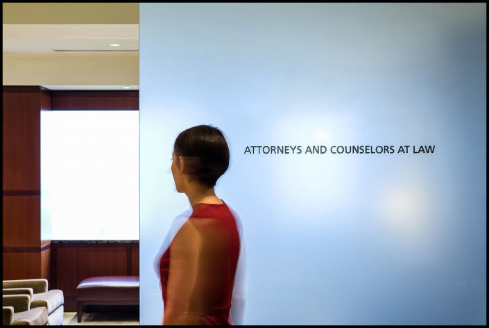 Michael LoBiondo Photography - Person moving in front of attorney sign in lobby of office