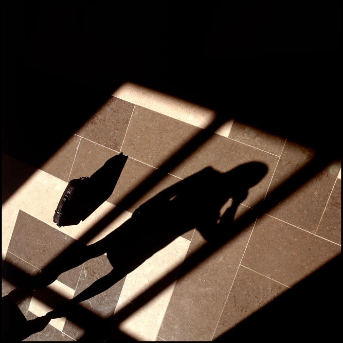 Michael LoBiondo Photography - shadow of corporate executive on phone in lobby