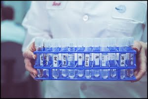 MIchael LoBiondo Photography - Hands holding a rack of vials