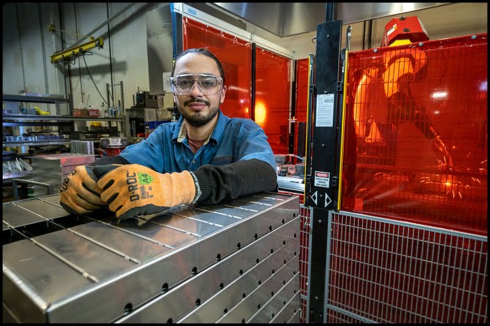 Michael LoBiondo Photography - environmental portrait of fabricator in front of robot and sparks