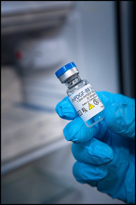 Michael LoBiondo Photography - blue gloved hand holding presription vial