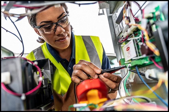Michael LoBiondo Photography - female gas pump technician repairing electrical circuit board