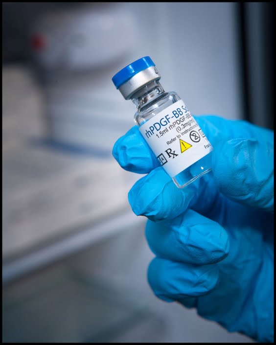 MIchael LoBiondo Photography - Blue gloved hand holding vial of medicine