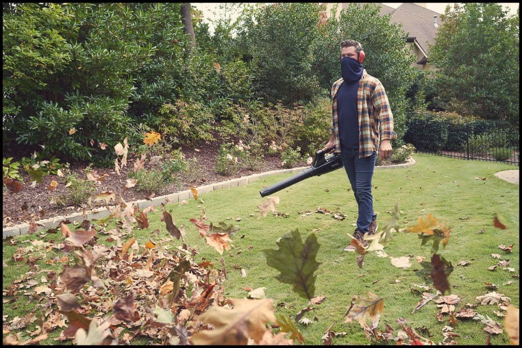 Michael LoBiondo Photography - Man blowing leaves wearing protective gaiter over mouth