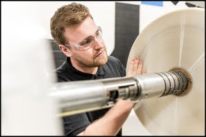 lobiondo-industrial-plastics-manufacturing-sheet Michael LoBiondo Photography - Technician inspecting plastic sheet roll during cutting - shot by Michael LoBiondo Photography