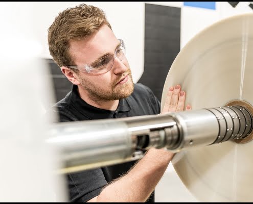 lobiondo-industrial-plastics-manufacturing-sheet Michael LoBiondo Photography - Technician inspecting plastic sheet roll during cutting - shot by Michael LoBiondo Photography