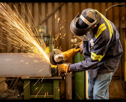 Grinding structural steel during fabrication operations. Grinding structural steel during fabrication operations.