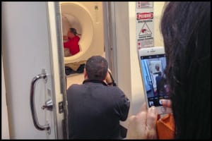 Behind the scenes of a medical photography shoot showing a photo Behind the scenes of a medical photography shoot showing a photographer capturing an MRI imaging maintenance.