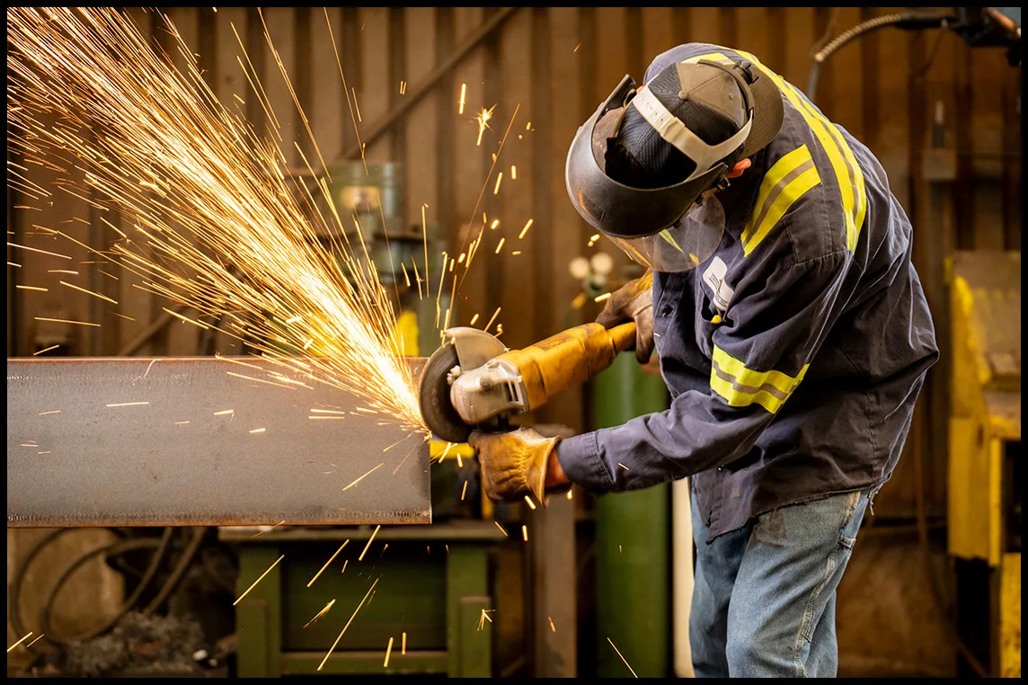 Grinding structural steel during fabrication operations. Grinding structural steel during fabrication operations.