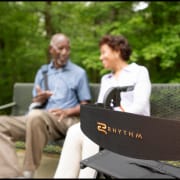 Senior couple talking outdoors with portable oxygen concentrator