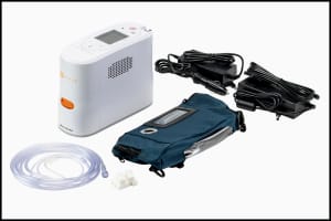 Portable oxygen concentrator with carrying accessories on white Portable oxygen concentrator with carrying accessories on white