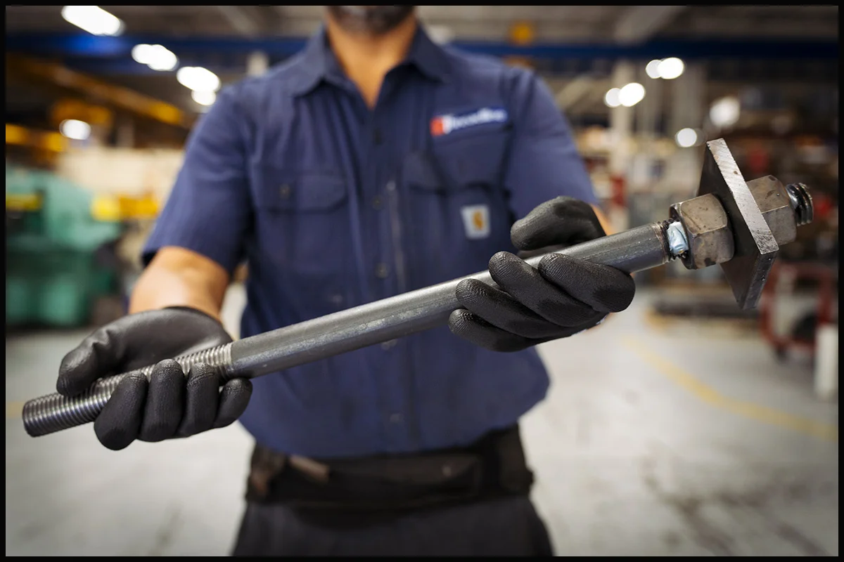 industrial-metal-component-product-photography-4243 Industrial worker holding a fabricated metal component for product photography