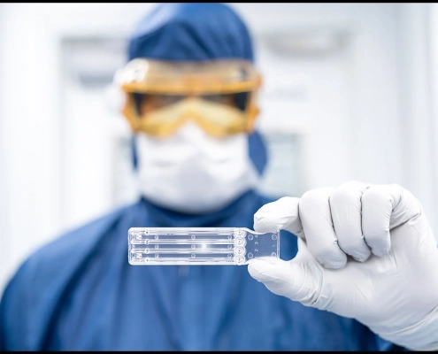 pharmaceutical-cleanroom-medical-device-product-photography-0954 Pharmaceutical cleanroom technician holding a medical device component